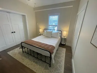 a bedroom with a bed with white sheets and a window at The Innwoods - One Bedroom Apartment in Tannersville