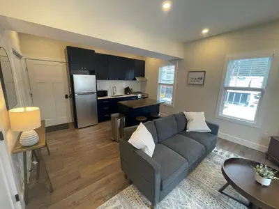a living room with a couch and a kitchen at The Innwoods - One Bedroom Apartment in Tannersville