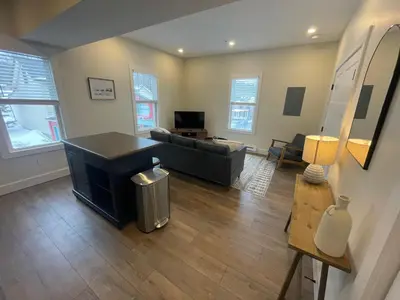 a living room with a couch and a television at The Innwoods - One Bedroom Apartment in Tannersville