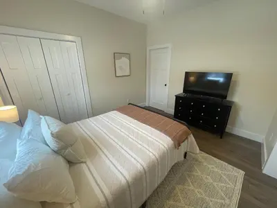 a bedroom with a bed and a flat screen tv at The Innwoods - One Bedroom Apartment in Tannersville