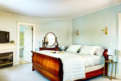a bedroom with a bed and a fireplace at Gateways Inn in Lenox