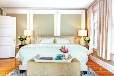 a bedroom with a large white bed with a table at Gateways Inn in Lenox