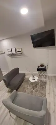 a living room with a couch and a table at Adam Clayton Apartment in New York