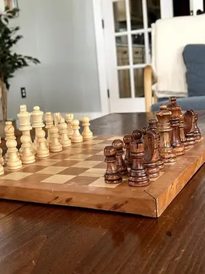 a wooden chess set on a wooden chess board at Bright, Airy Home in Hudson! in Hudson