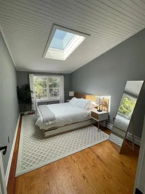 a bedroom with a bed and a skylight at Bright, Airy Home in Hudson! in Hudson