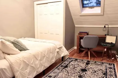 a bedroom with a bed and a desk and a chair at Bright, Airy Home in Hudson! in Hudson