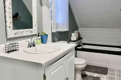 a white bathroom with a sink and a toilet at Bright, Airy Home in Hudson! in Hudson