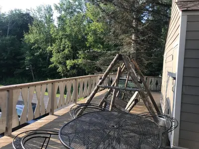 a table and chairs on a balcony with a ladder at 4BR ski on ski off Hunter Mountain Highlands Condo in Hunter