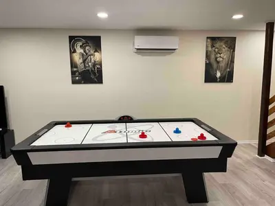 a ping pong table in a living room with at Gorgeous house private pool hot tub playroom in Long Pond