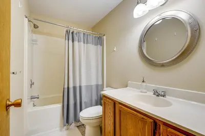 a bathroom with a sink and a toilet and a mirror at Less Than 1 Mi to Mt Snow Charming Condo with Fireplace in Dover