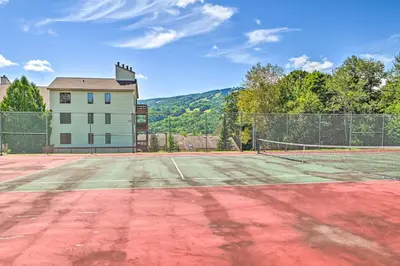 a tennis court in front of a house at Less Than 1 Mi to Mt Snow Charming Condo with Fireplace in Dover