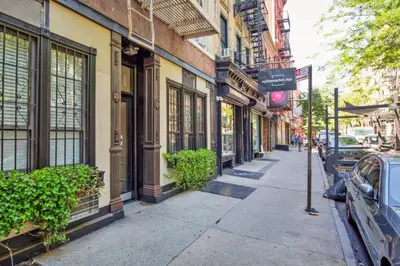 a city street with buildings and a street sign at Blueground Nolita wd ac nr Little Italy NYC-1570 in New York