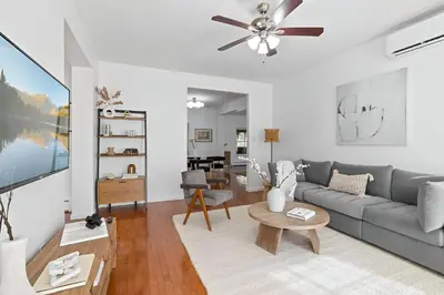 a living room with a couch and a table at Peaceful Paradise , Dream Holiday Home in Woodridge in Mountain Dale