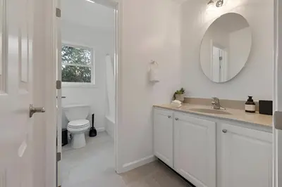 a white bathroom with a sink and a toilet at Peaceful Paradise , Dream Holiday Home in Woodridge in Mountain Dale