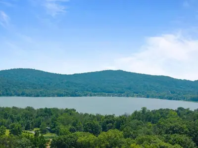 a view of a lake with mountains in the background at The Luxe Nook, Premier Studio in Scenic Congers in Congers