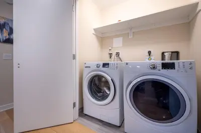 a laundry room with a washer and dryer at Modern Apt Downtown in Stamford