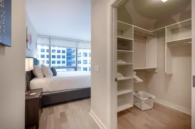 a bedroom with a bed and a large window at Modern Apt Downtown in Stamford