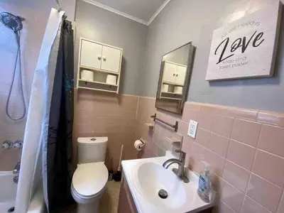 a bathroom with a white toilet and a sink at Cozy 1 BR, walk to subway, Free WiFi & Parking in Belleville