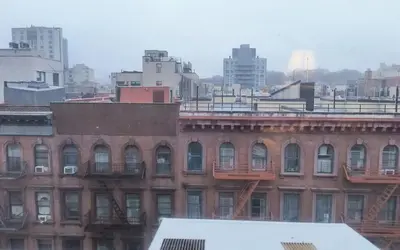 a large brick building with balconies in a city at My apartment in New York
