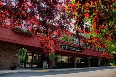a red building with a sign for the inn at The Inn at Crumpin-Fox in Bernardston