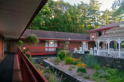 a house with a garden in front of it at The Inn at Crumpin-Fox in Bernardston