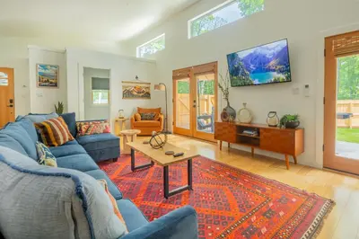a living room with a blue couch and a table at Sauger home in Saugerties