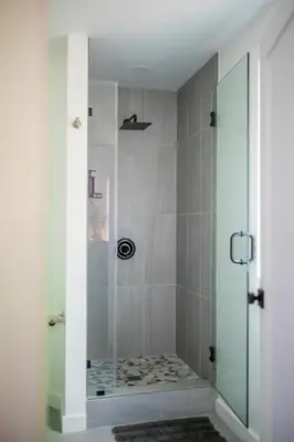 a shower with a glass door in a bathroom at Sauger home in Saugerties