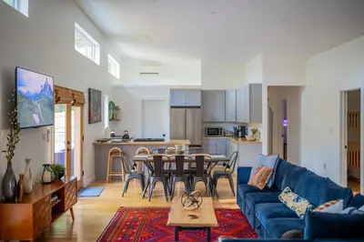 a living room with a blue couch and a table at Sauger home in Saugerties