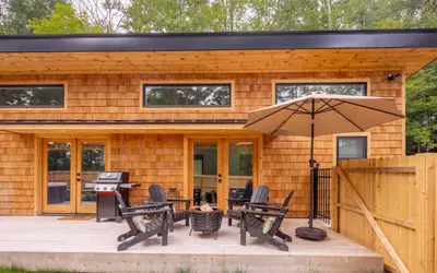 a house with a patio with chairs and an umbrella at Sauger home in Saugerties