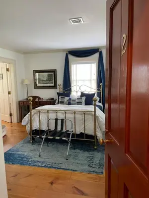 a bedroom with a bed with a blue canopy at White hollow farm in Salisbury