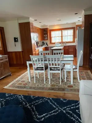 a kitchen with a white dining table and chairs at White hollow farm in Salisbury