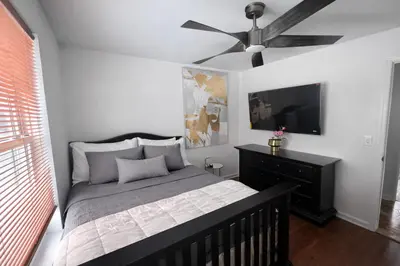 a bedroom with a bed and a ceiling fan at Tremont Hidden Treasure in East Orange