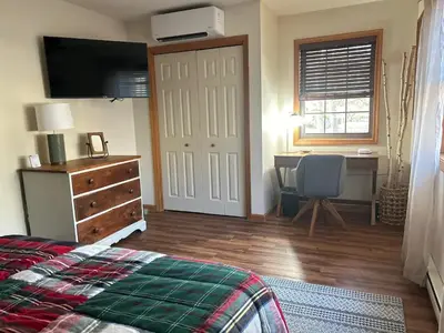 a bedroom with a bed and a desk and a television at EVPg in Lehigh
