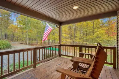 a porch with a bench and an american flag at EVPg in Lehigh