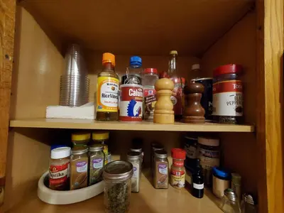 a cupboard filled with lots of spices and condiments at Pleasant Brook Cottage in Roxbury