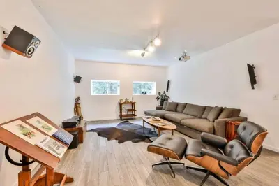 a living room with a couch and a table at Unique and Private 25ft Waterfall House in Hunter in Elka Park