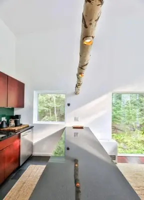 a kitchen with a spiral staircase in a house at Unique and Private 25ft Waterfall House in Hunter in Elka Park