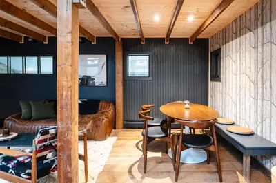 a dining room with a wooden table and chairs at Chic Catskills Cabin with Hot Tub and Fire Pit in Lanesville