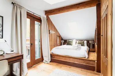 a bedroom with a bed and a window at Chic Catskills Cabin with Hot Tub and Fire Pit in Lanesville