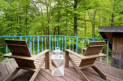 two chairs and a table on a deck at Chic Catskills Cabin with Hot Tub and Fire Pit in Lanesville