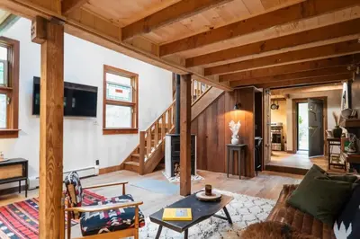 a living room with a couch and a table at Chic Catskills Cabin with Hot Tub and Fire Pit in Lanesville