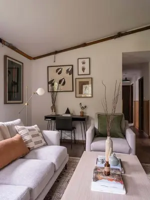 a living room with two couches and a table at Hunter Mountain View Cabin in Lanesville
