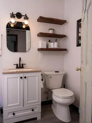 a bathroom with a toilet and a sink and a mirror at Hunter Mountain View Cabin in Lanesville