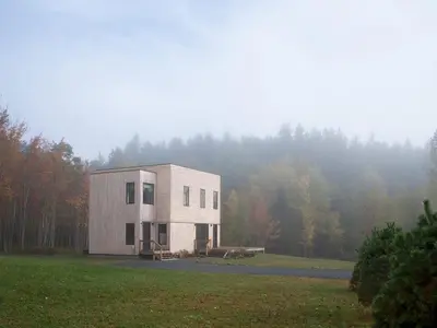 a small white building in a field with trees at Modern Mountain Retreat with Hot Tub in Fleischmanns