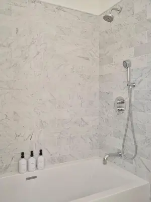 a white bathroom with a tub and a shower at Modern Mountain Retreat with Hot Tub in Fleischmanns