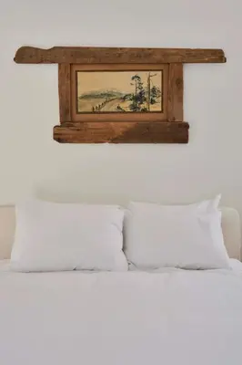 a picture on the wall above a bed with pillows at Modern Mountain Retreat with Hot Tub in Fleischmanns