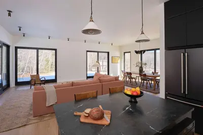 a kitchen and living room with a couch and a table at Modern Mountain Retreat with Hot Tub in Fleischmanns