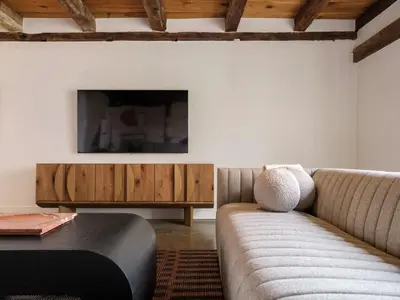 a living room with a couch and a flat screen tv at Chic Barn House with Pool in Germantown