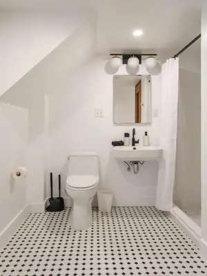 a white bathroom with a toilet and a sink at Chic Barn House with Pool in Germantown