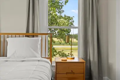 a bedroom with a bed and a window at Hudson Restored Farmhouse with Fire Pit in Hudson